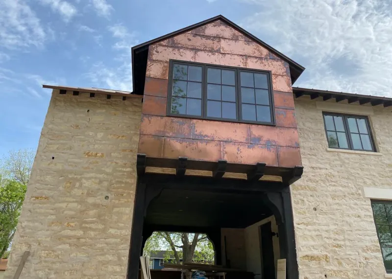 Copper metal panel facade on a stone building for Metal Roof Coating in Emerson